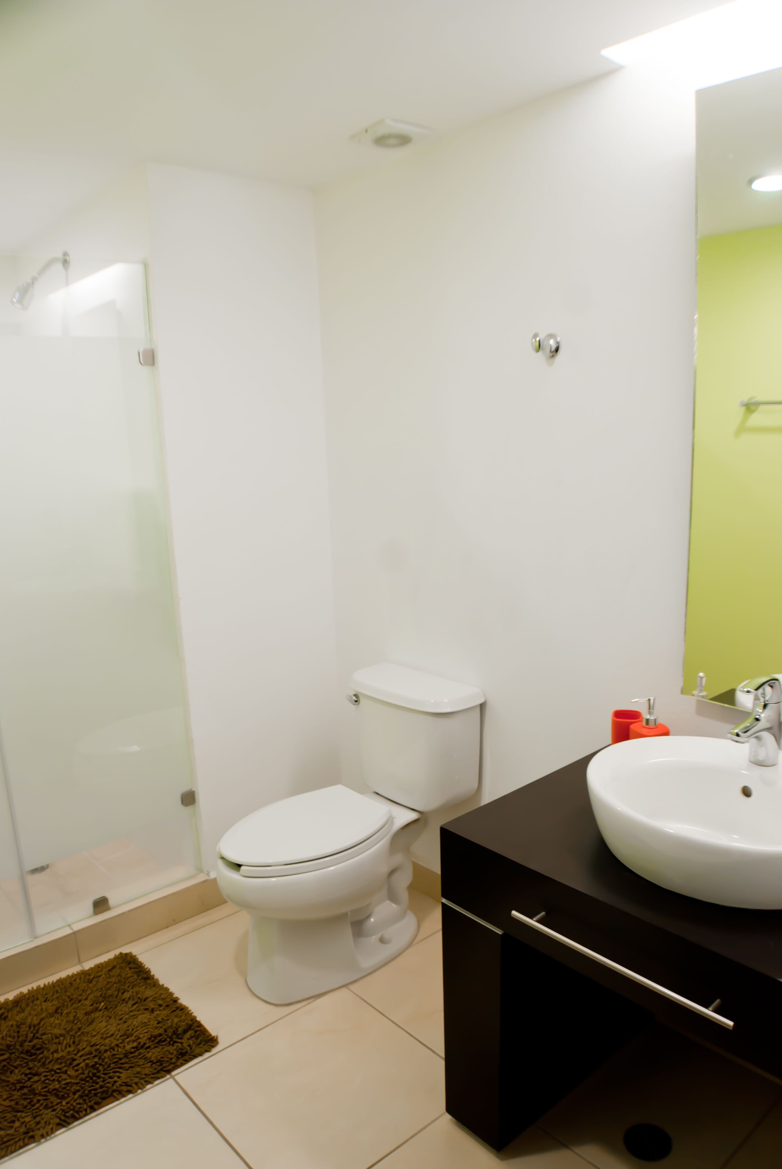 A bathroom with a toilet, a sink, and a shower.