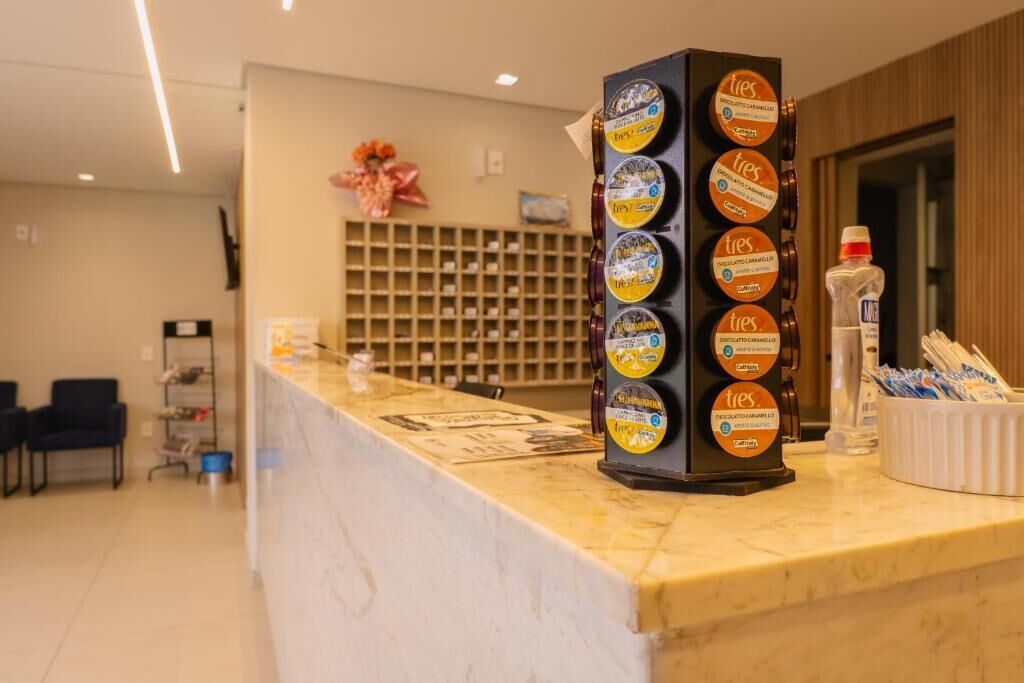 A reception desk with a display of chocolate bars and a water dispenser.