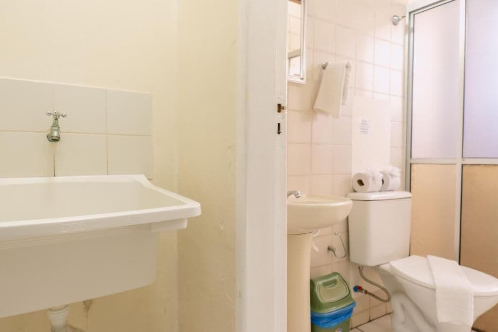 A bathroom with a sink, toilet, and shower.