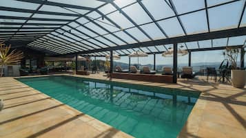 Indoor pool, open 10:00 AM to 10:00 PM, pool loungers