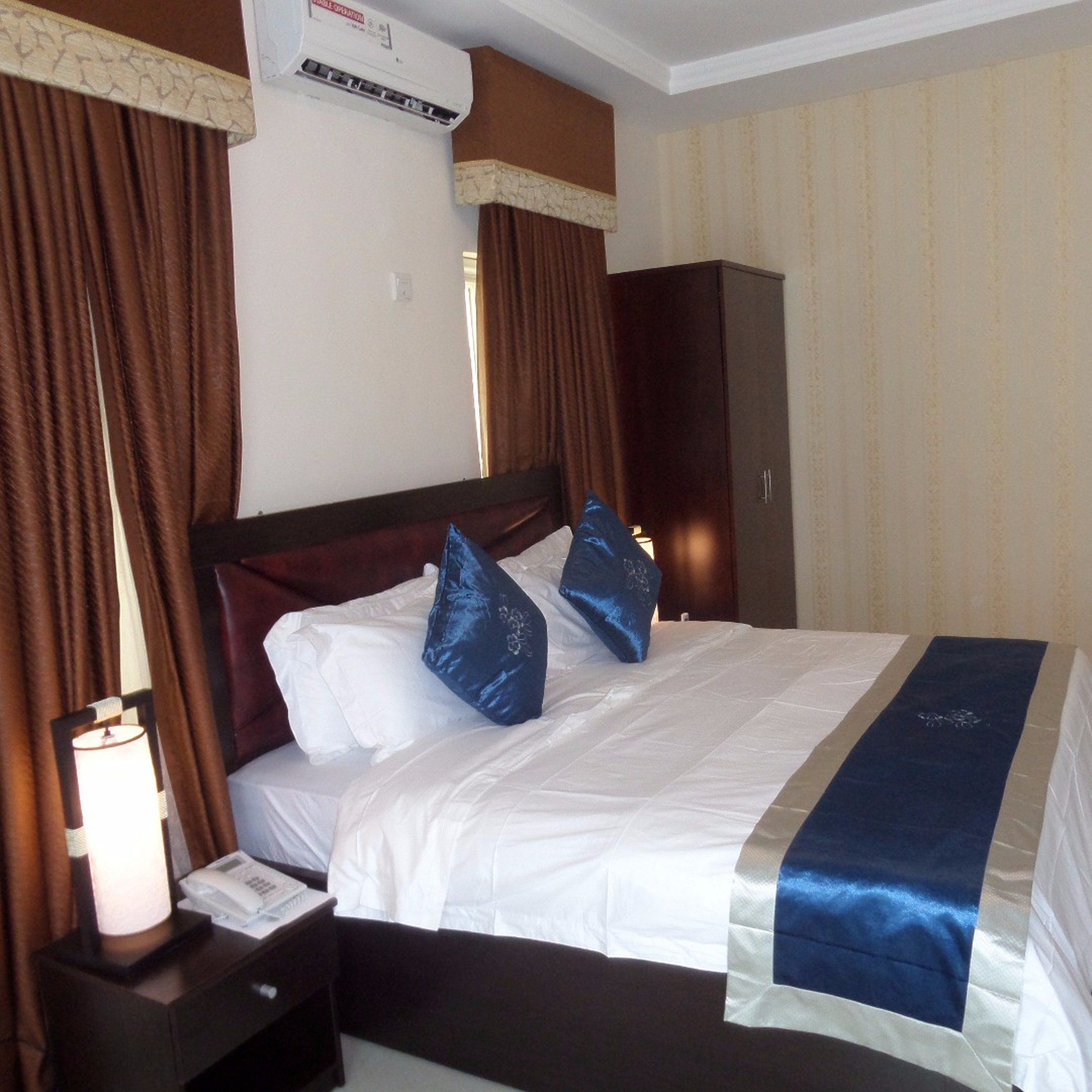 Desk, laptop workspace, blackout drapes, bed sheets