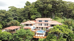 A two-story house with a swimming pool, surrounded by lush greenery. - Casa Marbella (Cóbano)