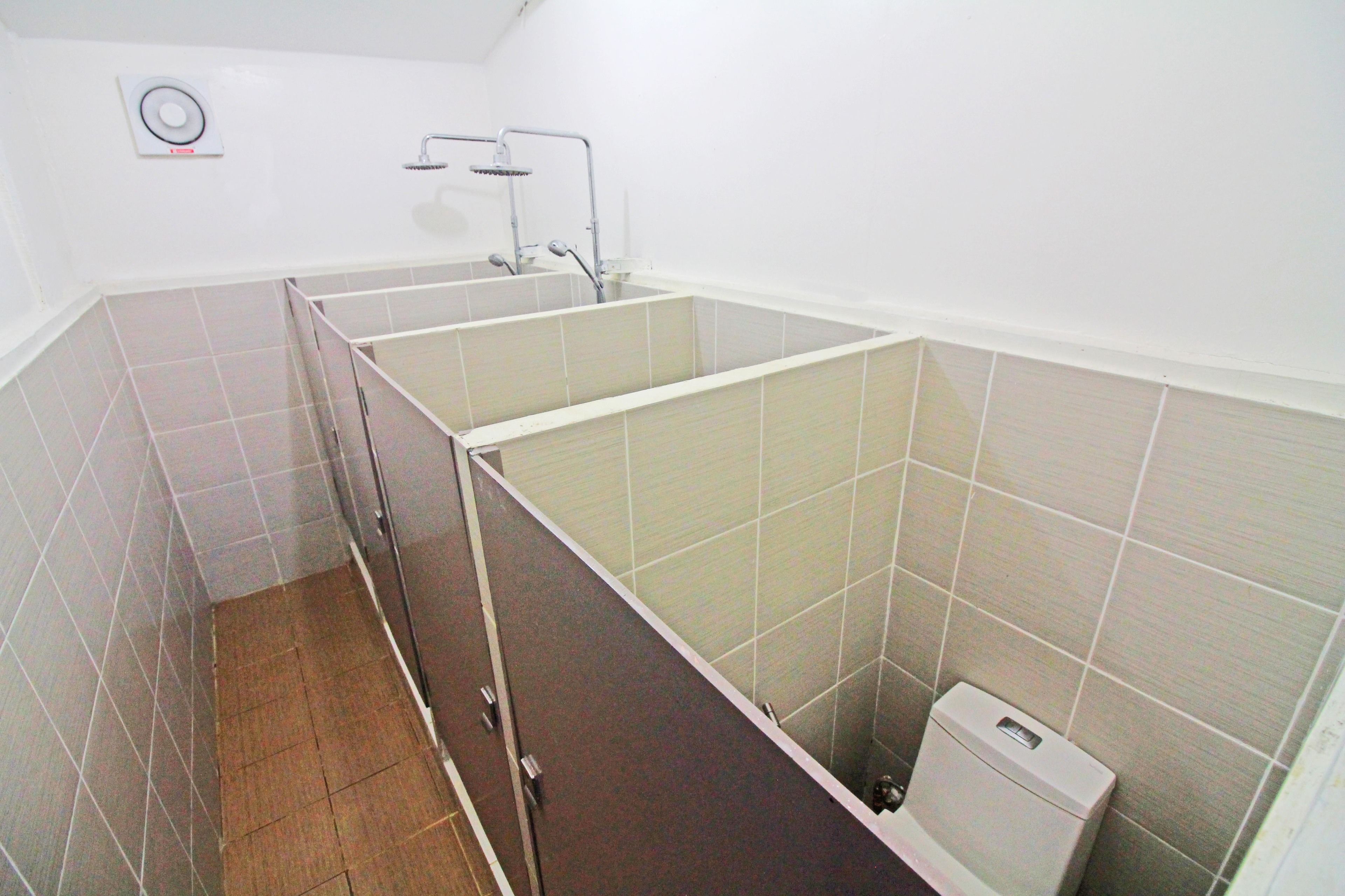A bathroom with a shower stall, a toilet, and a sink.