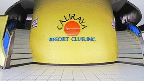 A building with a yellow exterior and a sign that reads "CALIRAYA RESORT CLUB, INC." - Caliraya Resort Club (Lumban)
