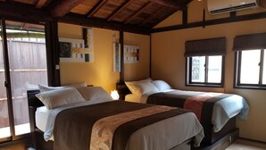 A room with two beds, wooden flooring, a ceiling fan, and a window with a view. - Kyonoyado Senkakubettei (Kyoto)
