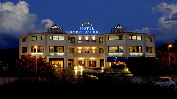 A multi-story hotel with a prominent sign reading "HOTEL TORRE DEL DUCA". - Hotel Torre del Duca (San Floro)