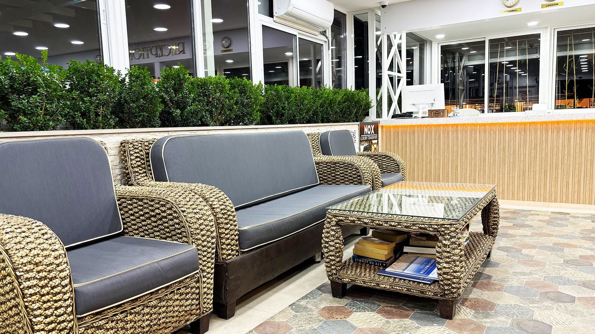 A reception area with a sofa, a coffee table, and a reception desk.