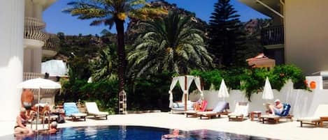 Piscine extérieure, parasols de plage, chaises longues