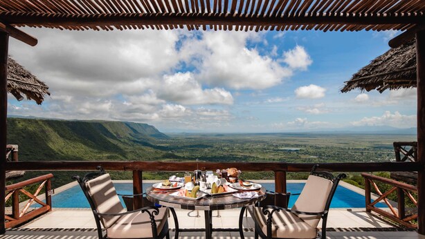 A table set for breakfast with a view of a mountainous landscape. - Lake Manyara Kilimamoja Lodge (Lake Manyara National Park)