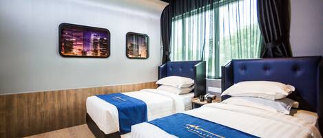 A hotel room with two beds, a cityscape view, and a modern design.