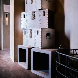 A stack of vintage-style suitcases with metal latches, placed on top of white storage boxes. - M Boutique Kampar (Kampar)