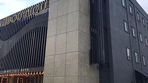 A modern building with a prominent logo and the text "Boutique Hotel" on the facade. - M Boutique Kampar (Kampar)