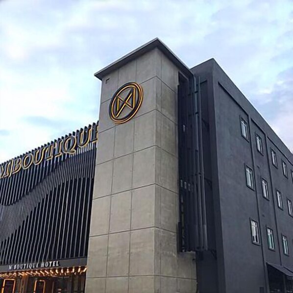 A modern building with a prominent logo and the text "Boutique Hotel" on the facade. - M Boutique Kampar (Kampar)