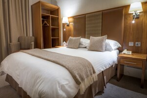 Hypo-allergenic bedding, desk, laptop workspace, blackout drapes