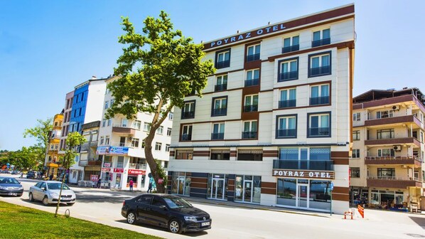 A multi-story hotel with a prominent sign reading "POYRAZ OTEL".