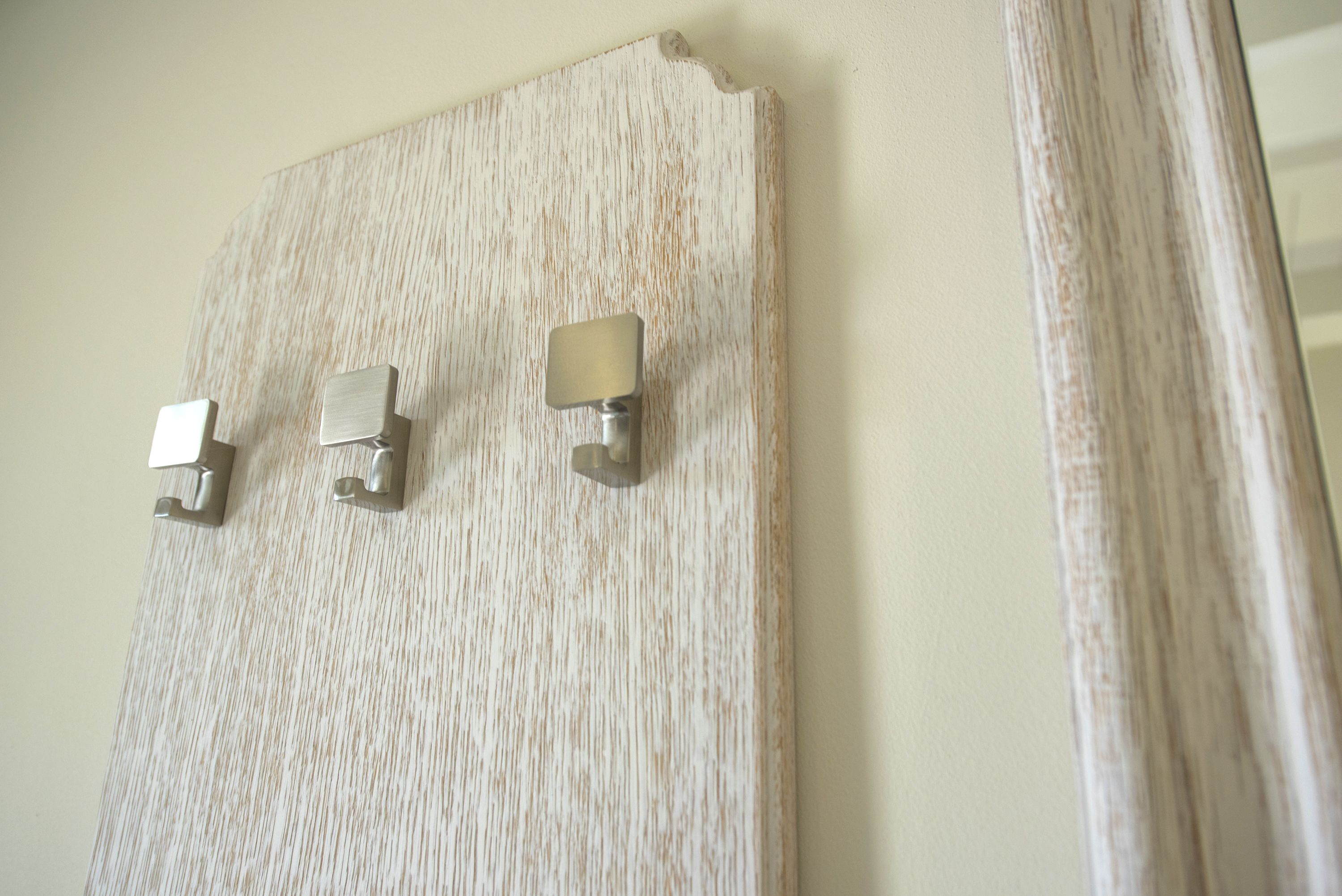 A textured wall with three metallic light fixtures.
