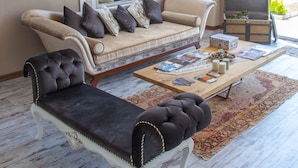 A living room with a sofa, armchair, and a coffee table. - Room Room Boutique Hotel (Sapanca)