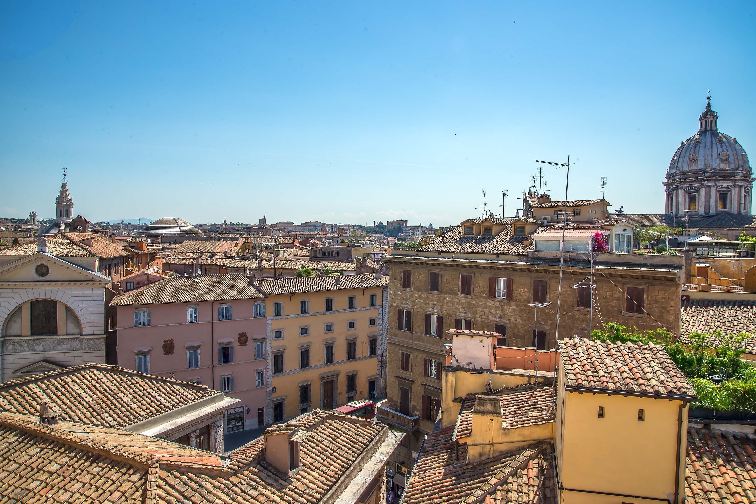 A cityscape with historic buildings, a prominent dome, and a clear sky.
