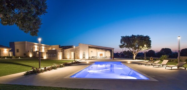 A modern house with a swimming pool and outdoor seating area.