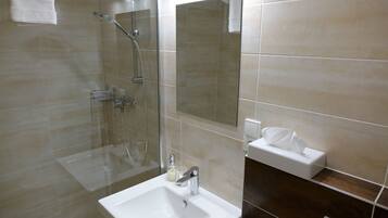 Shower, designer toiletries, hair dryer, towels