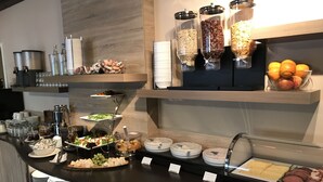 A buffet setup with various food items and condiments. - Hotel Traumblick (Cochem)