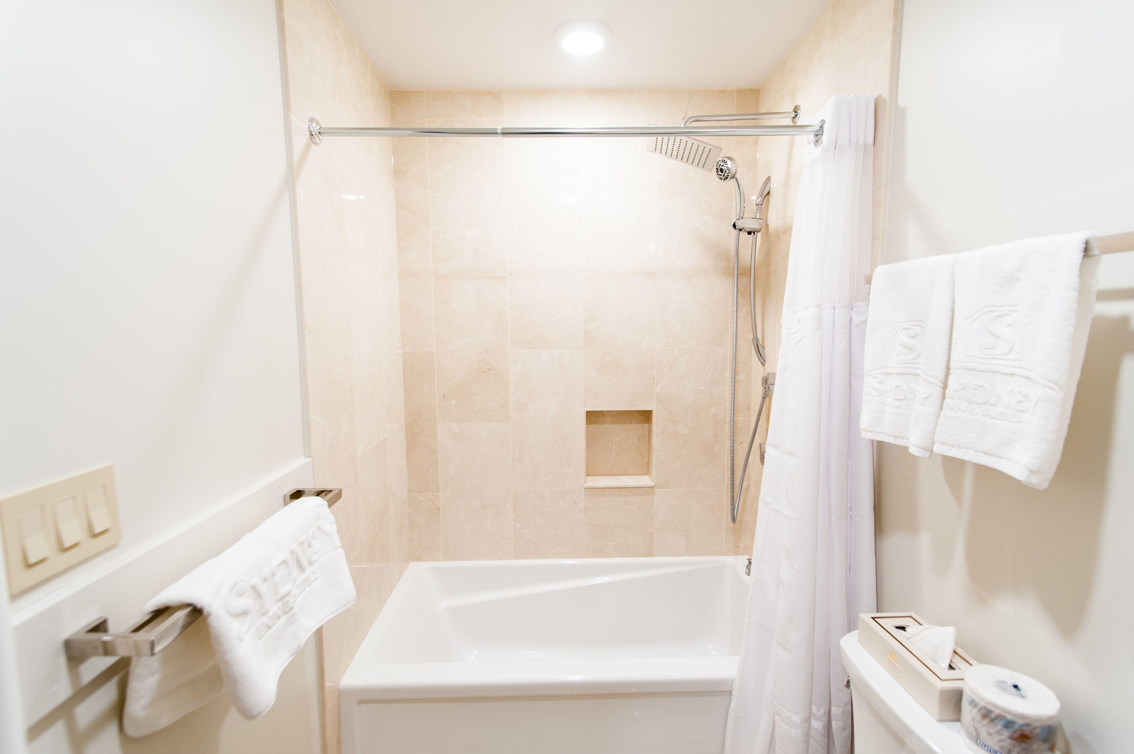 Un baño moderno con bañera, ducha e inodoro.