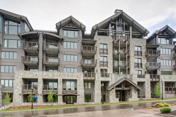 A multi-story hotel with balconies, stone facade, and a central entrance. - The Lion (Vail)