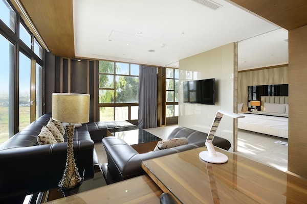 Grand Triple Room, 1 Bedroom, Bathtub | Living room | LCD TV