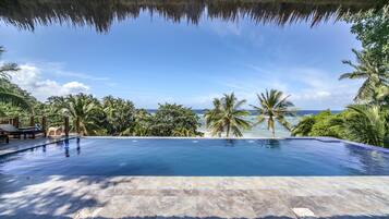 Outdoor pool, an infinity pool, pool umbrellas, pool loungers