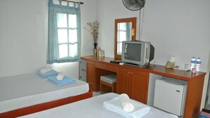 A hotel room with two beds, a small desk with a television, a mirror, and a refrigerator. - Chill Beach Resort (Pathio)