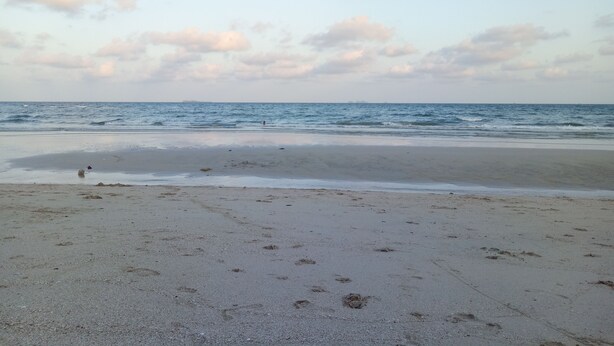 A beach with a wide sandy area and gentle waves. - Chill Beach Resort (Pathio)