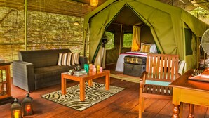 A tented accommodation with a sofa, a wooden table, and a bench. - Ahaspokuna by Eco Team (Balangoda)
