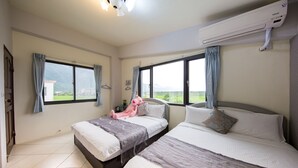 A bedroom with two beds, a large window, and an air conditioning unit. - Slow Fly B&B (Xincheng)