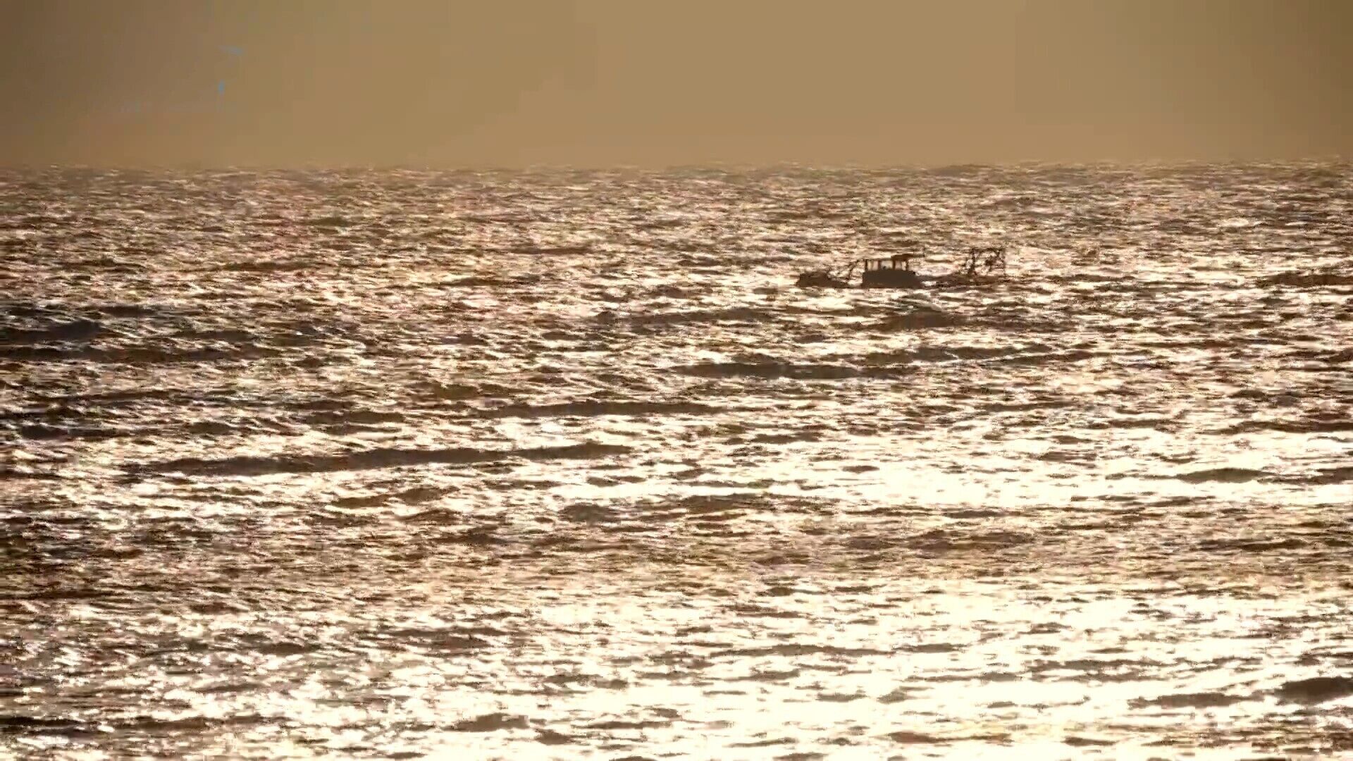A body of water with a distant structure, possibly a pier or dock.