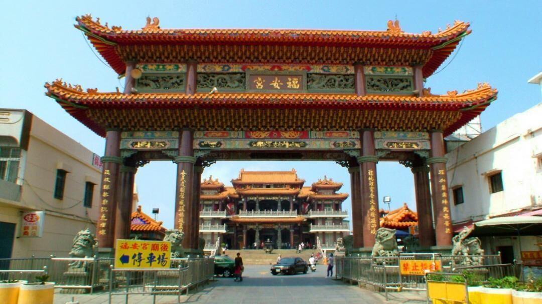 A traditional Chinese gate with intricate designs and a multi-tiered roof structure.