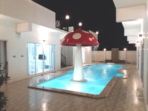 Una piscina al aire libre, una piscina con cascada