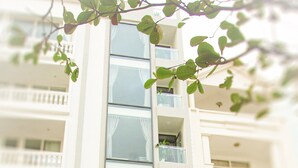 The exterior of the An Hoi Canary Hotel with a clear view of the entrance, a motorcycle parked outside, and a potted plant to the right. - An Hoi Canary Hotel (Da Nang)