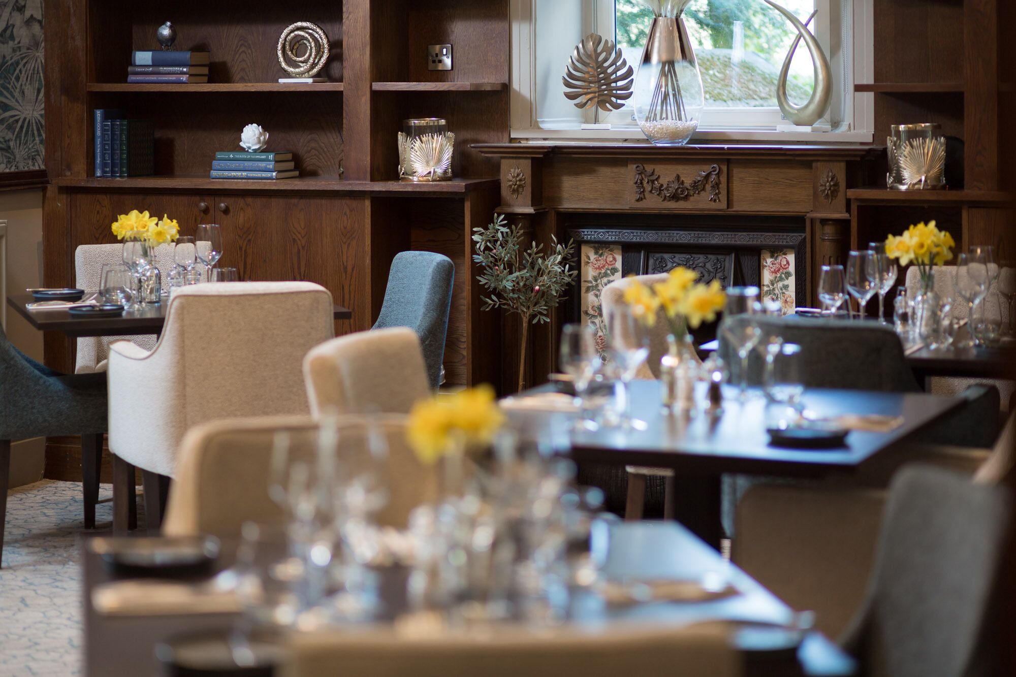 A dining area with a fireplace, wooden furniture, and decorative items.