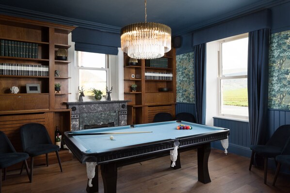 A billiards room with a pool table, bookshelves, and a fireplace. - Aysgarth Falls Hotel (Leyburn)