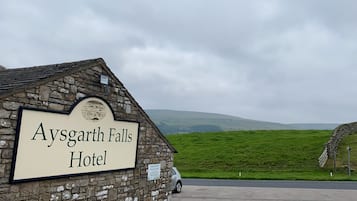 En byggnad av sten med en skylt som visar texten ”Aysgarth Falls Hotel”.