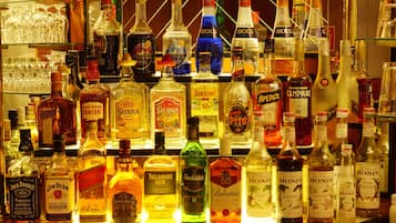 A bar with various bottles of alcohol, including whiskey, tequila, and other spirits.