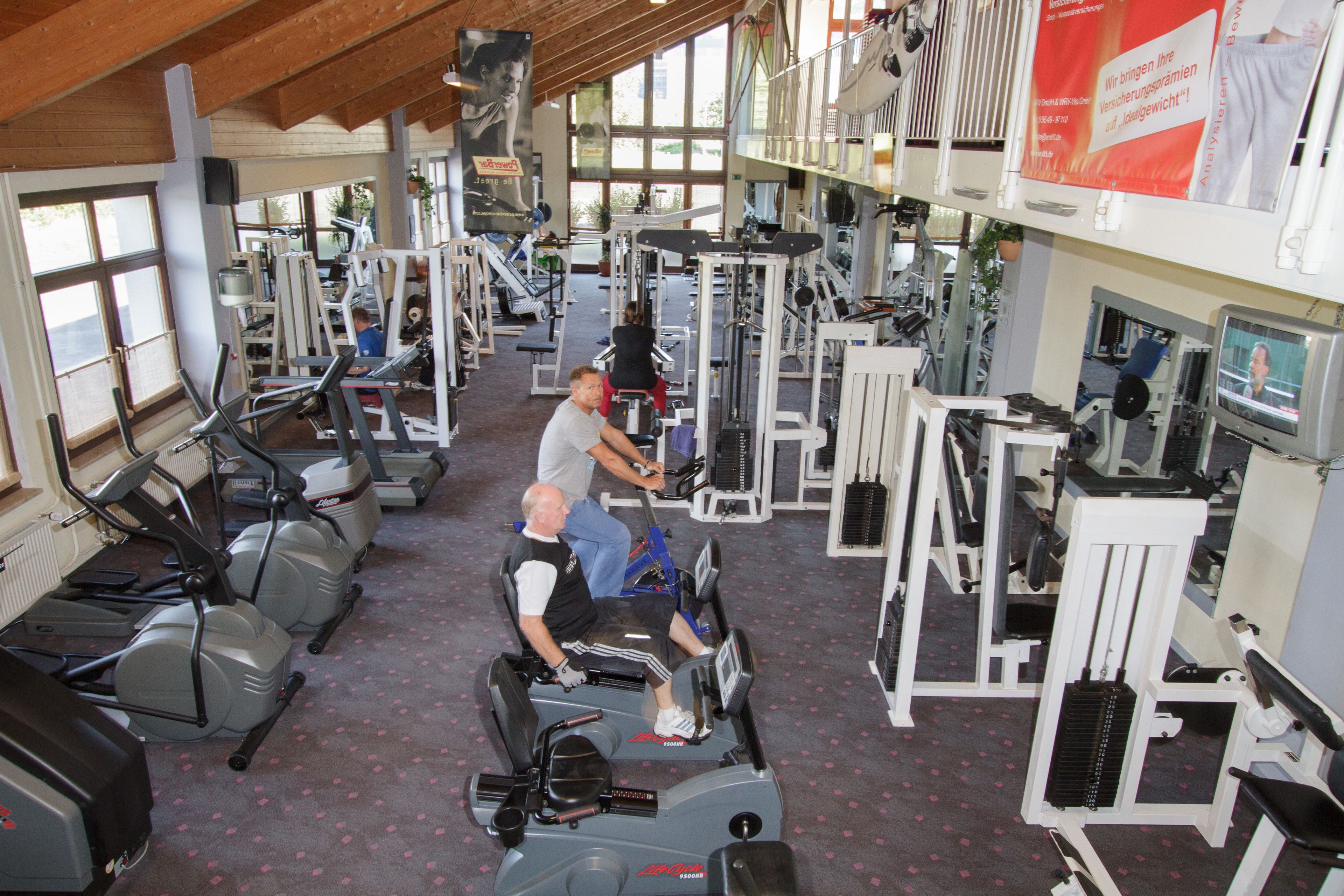 A gym with various exercise equipment, including treadmills and weight machines.
