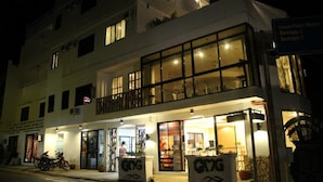 A multi-story building with a ground-level restaurant and a balcony on the second floor. - GMG Hotel (Coron)