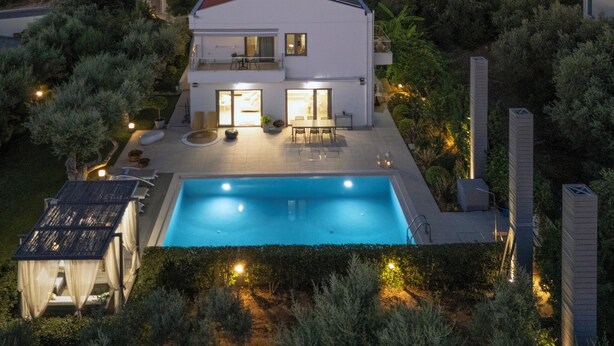 A modern two-story house with a swimming pool, outdoor seating, and solar panels. - Sunlight Breeze Villa (Chania)