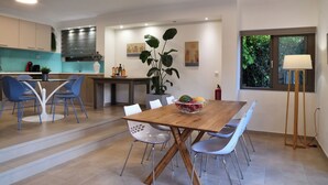 A modern kitchen with a dining area. - Sunlight Breeze Villa (Chania)