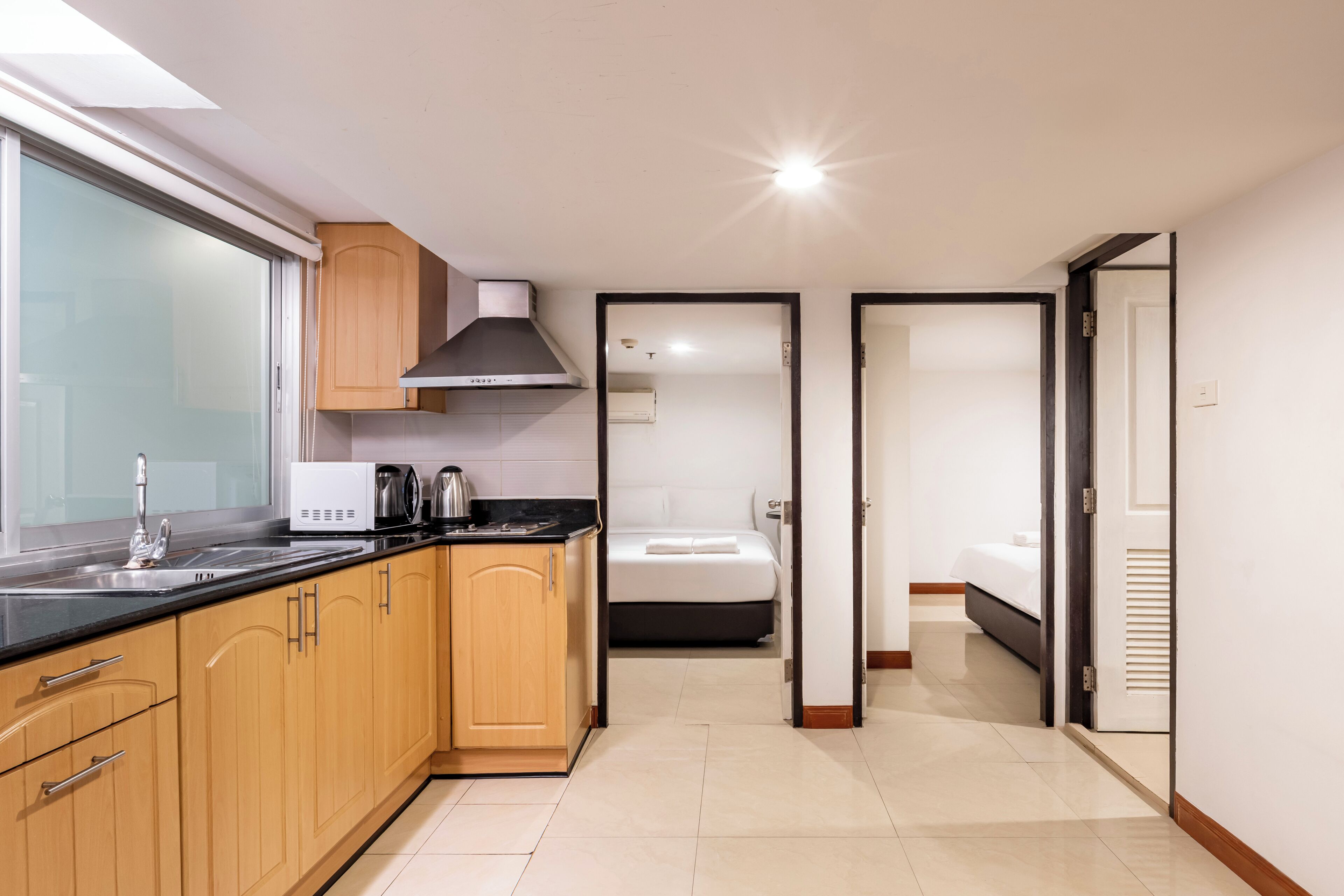 Economy Apartment, 2 Bedrooms | Private kitchen | Fridge, microwave, cookware/dishes/utensils, dining tables