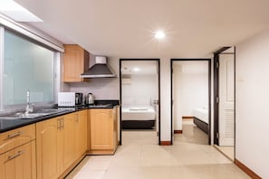 Economy Apartment, 2 Bedrooms | Private kitchen | Fridge, microwave, cookware/dishes/utensils, dining tables