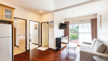 Family Apartment, Pool View | Living area | 40-inch flat-screen TV with cable channels