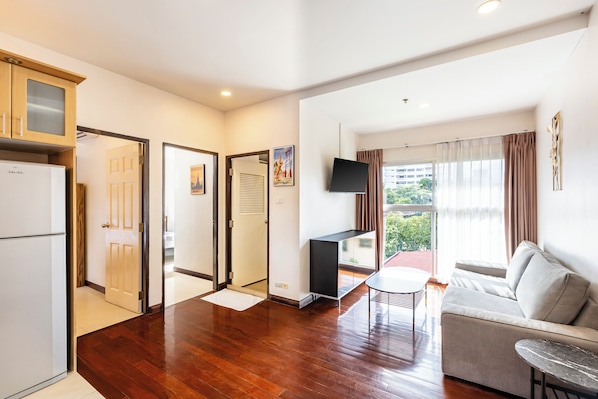 Family Apartment, Pool View | Living area | 40-inch flat-screen TV with cable channels