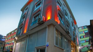 A multi-story hotel with a modern facade, large windows, and a visible guestroom sign. - Flats Company - Karakoy Apartment (Istanbul)